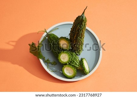 Top view of a dish in round-shaped of bitter melon. Bitter melon (Momordica charantia) is an excellent source of vitamins B1, B2, B3, and C Royalty-Free Stock Photo #2317768927