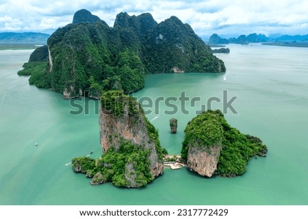 Khao Tapu, James Bond Island, aerial shot from a drone, blue sea, emerald green, is a popular tourist attraction in Southern Thailand. Royalty-Free Stock Photo #2317772429