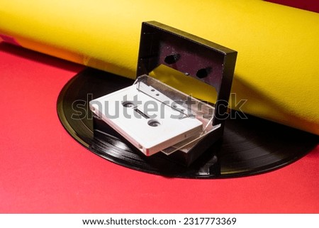 vintage old music tape cassette on yellow and red backgrounds - vinyl record 