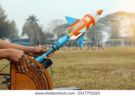water rocket on launch pad. It is an activity that promotes science knowledge and skills for children. Children have thinking skills, problem-solving, creativity, happiness, and fun.                   Royalty-Free Stock Photo #2317792565