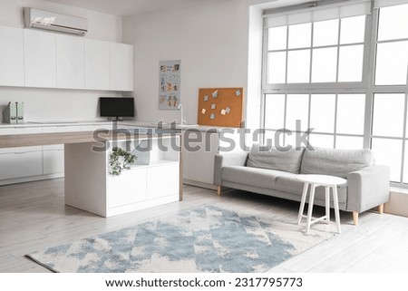 Interior of rehabilitation center with table and sofa Royalty-Free Stock Photo #2317795773