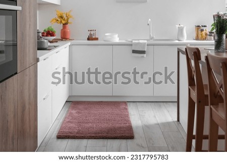 Stylish brown carpet in interior of modern kitchen