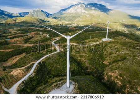 Aerial shot of wind turbines in mountain, nature and ecology zero emission Royalty-Free Stock Photo #2317806919