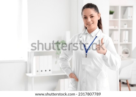 Female physiotherapist showing thumb-up in rehabilitation center Royalty-Free Stock Photo #2317807789