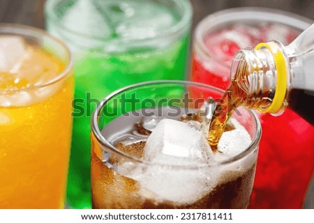 Soft drinks and fruit juice mixed with soda high in sugar have a negative effect on physical health Royalty-Free Stock Photo #2317811411