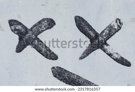 Abstract photo of old black paint against white background with two letter "X". Flat layout. Front view.