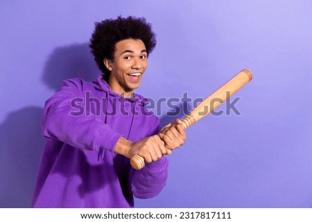 Photo of excited positive person have good mood hands hold baseball bat hit ball isolated on violet color background