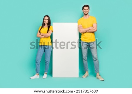 Photo of confident cute married couple wear yellow t-shirts arms crossed modern gadget empty space isolated teal color background Royalty-Free Stock Photo #2317817639