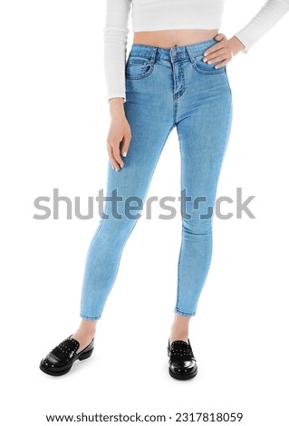 Young woman in skinny jeans on white background Royalty-Free Stock Photo #2317818059