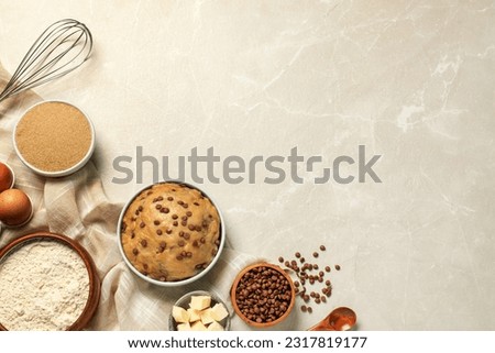 Dough and ingredients for cooking chocolate chip cookies on light grey table, flat lay. Space for text Royalty-Free Stock Photo #2317819177