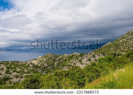 Storm clouds on the Adriatic coast of Croatia south of the village of Sveti Juraj in Lika-Senj county, late spring Royalty-Free Stock Photo #2317888573