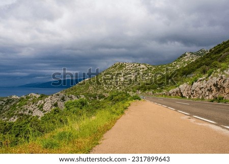 Storm clouds on the Adriatic coast of Croatia south of the village of Sveti Juraj in Lika-Senj county, late spring. Looking north Royalty-Free Stock Photo #2317899643