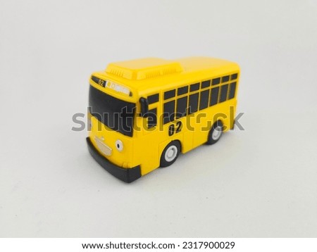 Yellow children's toy bus on a white background.  stock photos