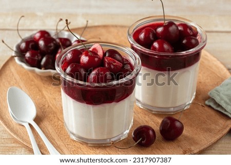sweet cherry jelly mousse dessert in glass,  selective focus Royalty-Free Stock Photo #2317907387