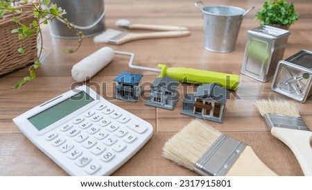Calculator and painting tools.Estimate for outer wall repair. Royalty-Free Stock Photo #2317915801