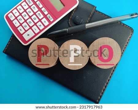Business concept. PPO text written at wooden blocks with notebook, pen and calculator on blue background.  Royalty-Free Stock Photo #2317917963