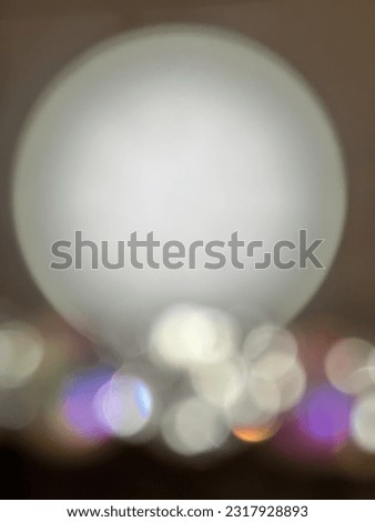 An abstract picture of bright white round shape in bokeh effect looks like a full moon