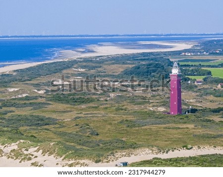 Drone picture of Ouddorp lighthouse in Holland with surrounding dunes during daytime in summer