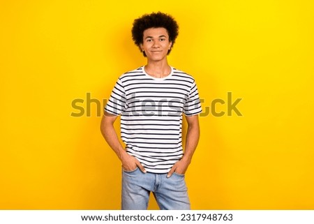 Photo of young man wear trendy casual clothes t-shirt denim pants hands pockets posing for yoox store isolated on yellow color background