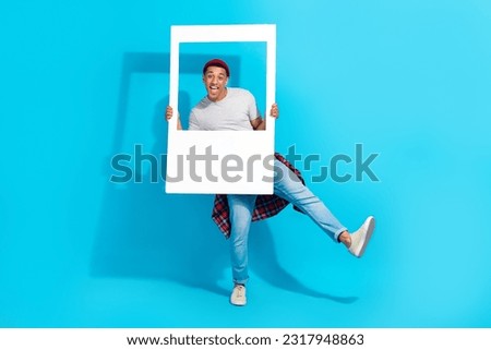 Full length portrait of overjoyed carefree person have good mood dancing hold paper album card isolated on blue color background