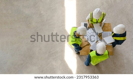 top view engineer discuss meeting together with architect foreman team while inspecting material of infrastructure construction progress for sustainable green building at site preparation copy space Royalty-Free Stock Photo #2317953363