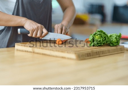 Prepare food  woman is preparing vegetable salad in the kitchen Healthy Food Healthy Cooking. Royalty-Free Stock Photo #2317953715