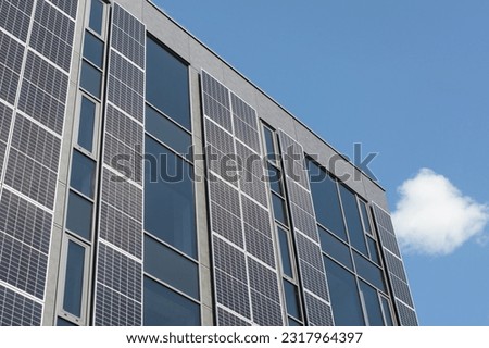 Modern building boasting a solar facade. Wall with solar panels on a modern building. Royalty-Free Stock Photo #2317964397