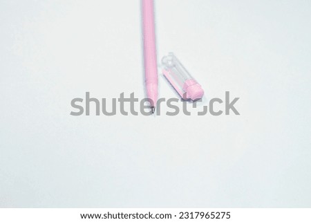 Ballpoint pen on a blue isolated background. Stationery items. Subject for writing