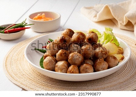 Thai Sausage Feast,fermented pork and rice sausage (Sai Krok Isan) in white plate with vegetables Royalty-Free Stock Photo #2317990877