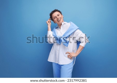 pensive young fashionable dark-haired woman in a cool look Royalty-Free Stock Photo #2317992381