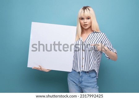 blonde young female adult in blouse holding white board isolated background
