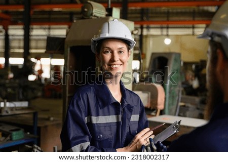 Mechanical engineers repairing engine machine at factory Royalty-Free Stock Photo #2318002317