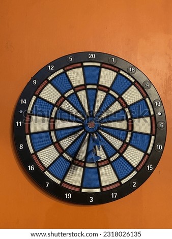 Round Dart Target hang on orange wall 