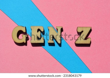 Gen Z, abbreviation for Generation Z, words in wooden alphabet letters isolated on pink and blue background as banner headline