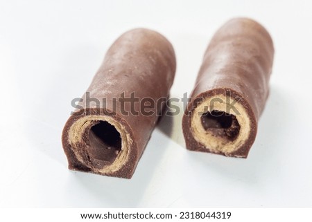 wafer filled with hazelnut cream and covered in milk chocolate on a white background