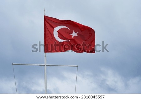 Turkey flag waving on the wind against cloudy sky during rainy day