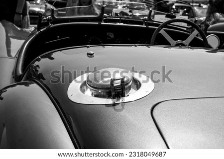 Stylish black and white closeup photo of backside Fuel Lid on metallic blue colour beautiful majestic classic car.