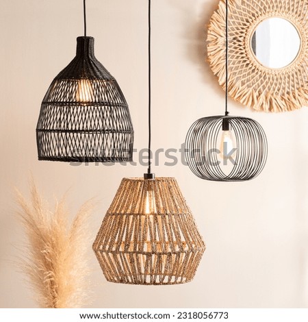 rattan style lighting fixtures hang on wall near decorative pieces Royalty-Free Stock Photo #2318056773