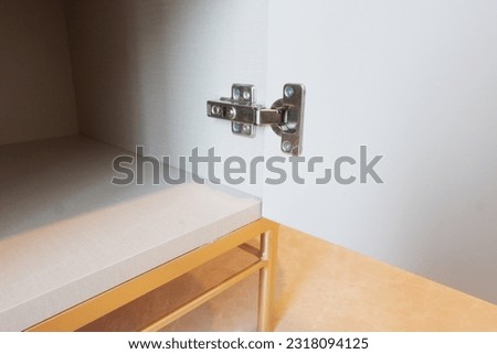 Modern and adjustable cabinet door hinges for furniture and interior, such as kitchen set and wardrobe Royalty-Free Stock Photo #2318094125