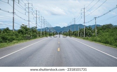 beautiful asphalt concrete road with electric pole on side way and mountain background.