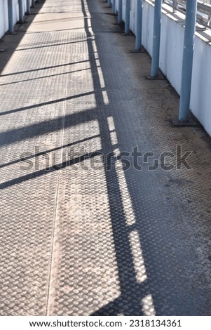 Sunlit Steel Plate Walkway Industrial Overpass Serenity