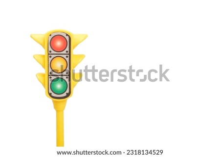 Yellow toy traffic light isolated on a white background. Royalty-Free Stock Photo #2318134529