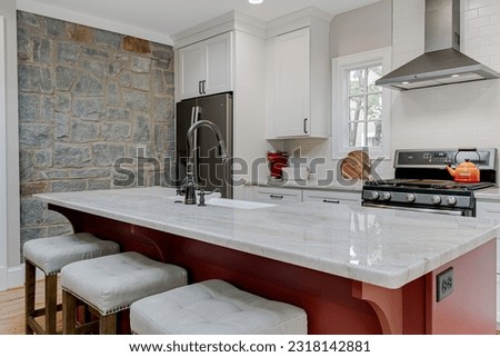 Luxury Spring Modern Kitchen Interior with White Marble Countertops and Red Island and Oval Window  Royalty-Free Stock Photo #2318142881