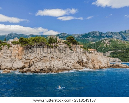 Young women Having Fun Stand Up Paddling in blue water sea near st stefan island in Montenegro. SUP