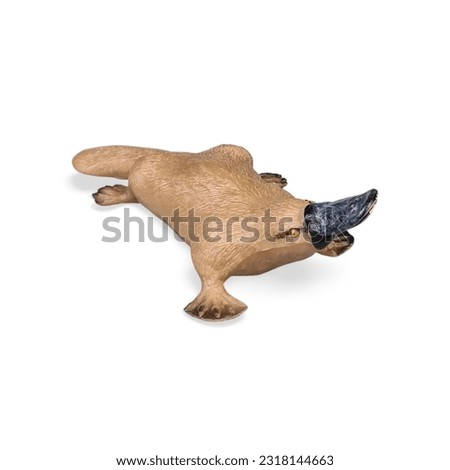 Close-up of a miniature platypus toy animal side view against a white background