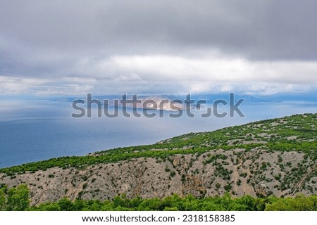 A stormy late spring on the Adriatic coast of Croatia near the town of Klada in Lika-Senj county. Looking towards Otok Prvic island Royalty-Free Stock Photo #2318158385