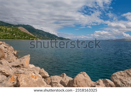 Rocks on the Adriatic coast of Croatia in the town of Karlobag in Lika-Senj county, late spring Royalty-Free Stock Photo #2318163325