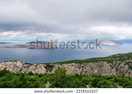 A stormy late spring on the Adriatic coast of Croatia near the town of Klada in Lika-Senj county. Looking towards Goli Otok island on the left with Otok Sveti Grgur behind it, and Otok Prvic right Royalty-Free Stock Photo #2318163327