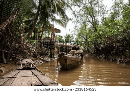 exploring narrow channels of the Mekong Delta in a small sampan boat