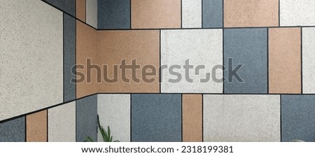mosaic wall, with soft color at corner. 